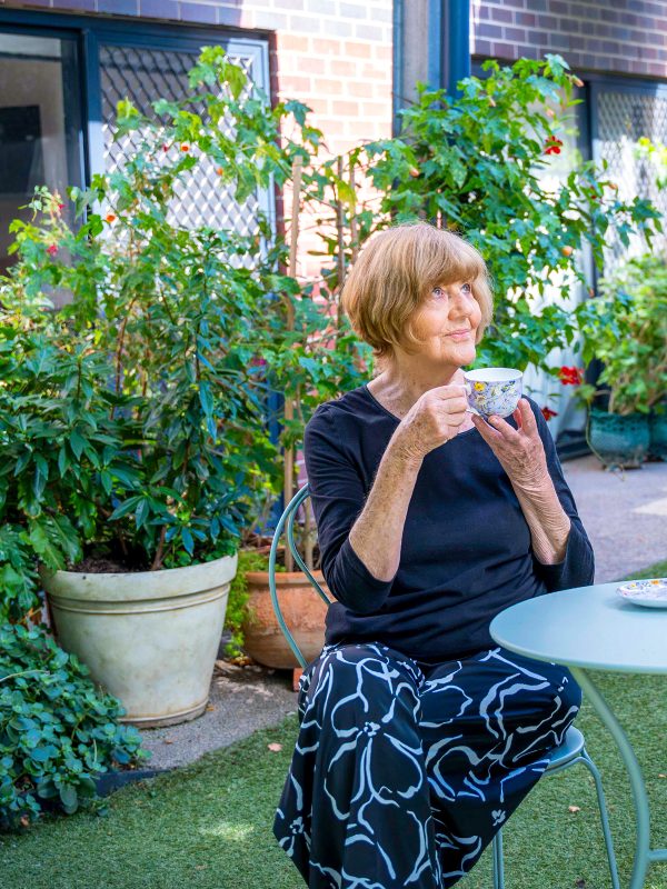 Resident outside her apartment at Westhaven