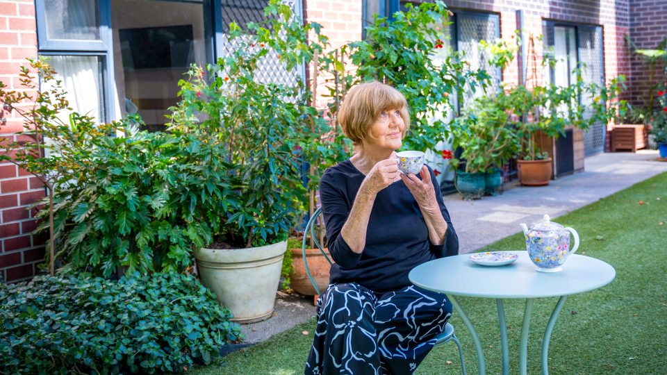 Resident outside her apartment at Westhaven