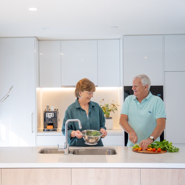 Retirement Living residents in their apartment preparing a meal