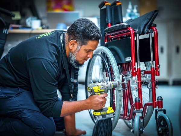 CAREERS Office Maintenance Officer fixing a wheelchair in a residential aged care home