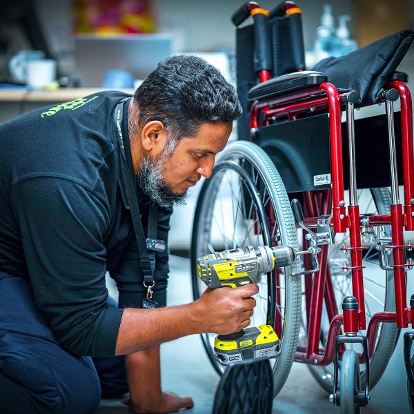 CAREERS Office Maintenance Officer fixing a wheelchair in a residential aged care home