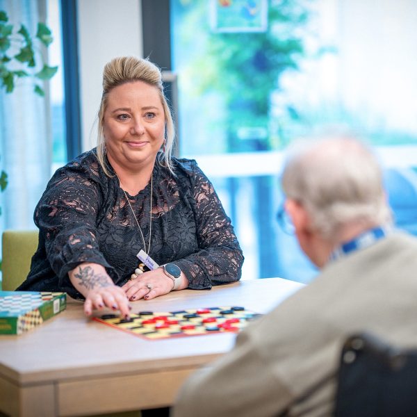 CAREERS Lifestyle Coordinator playing a game with a resident in a residential aged care home