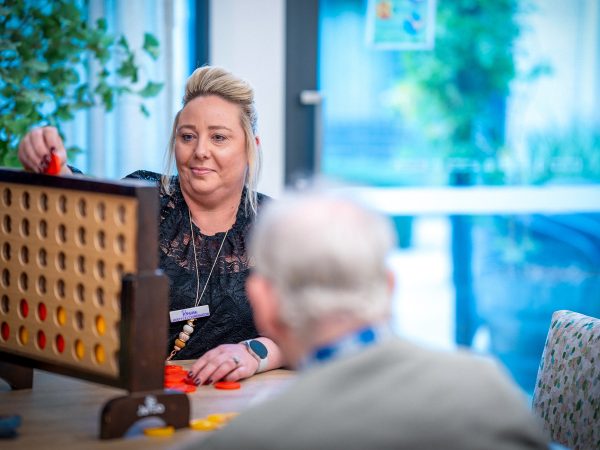 CAREERS Lifestyle Coordinator playing a game with a resident in a residential aged care home