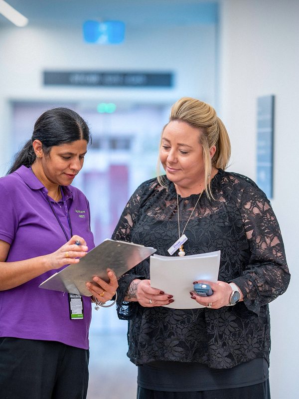 CAREERS Lifestyle Coordinator discussing activity plans with another staff member for the next month in a residential aged care home