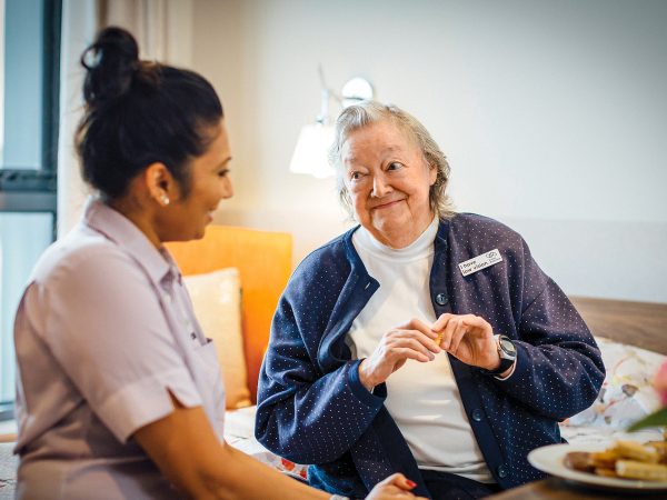 BAPTCARE THE ORCHARDS Resident with staff member engaged in conversation