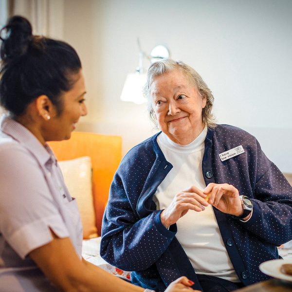 BAPTCARE THE ORCHARDS Resident with staff member engaged in conversation