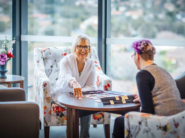 BAPTCARE THE ORCHARDS Resident with staff member enjoying board game