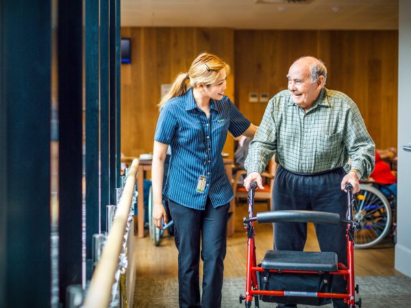 BAPTCARE THE ORCHARDS Resident and saff member together strolling