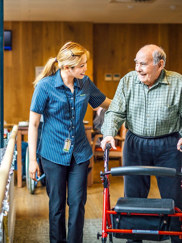 BAPTCARE THE ORCHARDS Resident and saff member together strolling