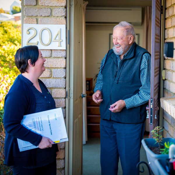 HOME CARE staff member with a customer at their home doing an assessment update