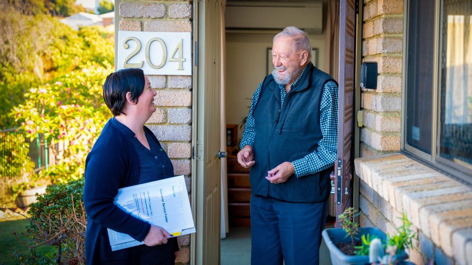 HOME CARE staff member with a customer at their home doing an assessment update