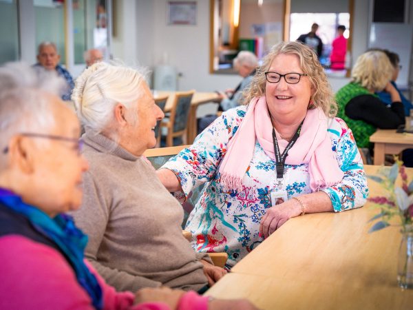 HOME CARE staff member chatting with Home Care Package customers coming for a lunchtime meal at Orana Social Activities and Respite Centre