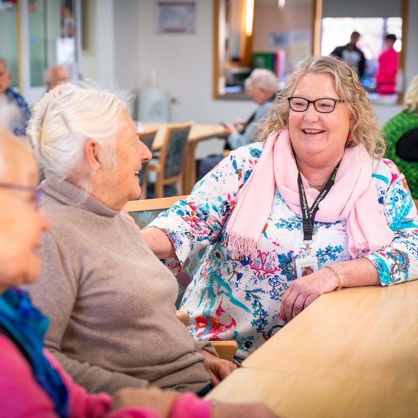 HOME CARE staff member chatting with Home Care Package customers coming for a lunchtime meal at Orana Social Activities and Respite Centre