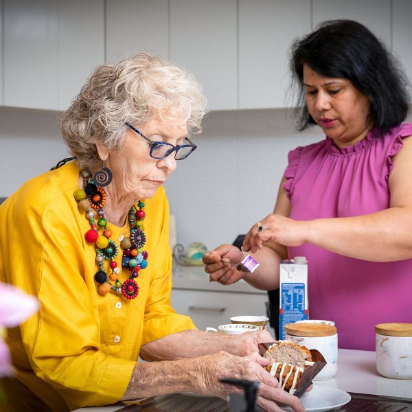 Lynette and her caseworker preparing morning tea