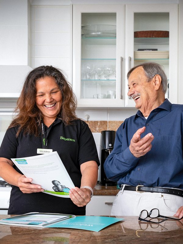 HOME CARE Matteo a Home Care Package customer with Baptcare laughing with a staff member