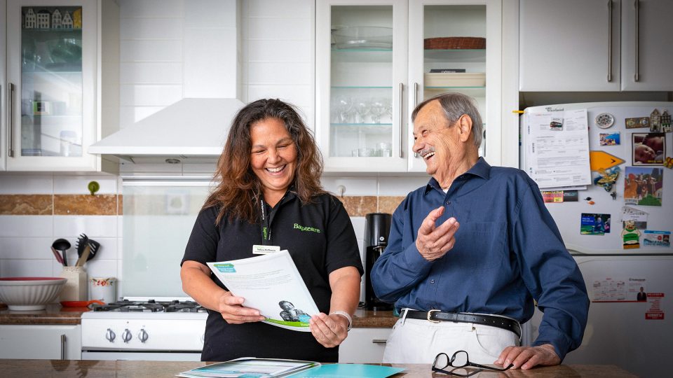 HOME CARE Matteo a Home Care Package customer with Baptcare laughing with a staff member