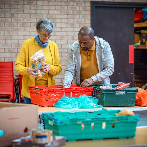 BAPTCARE AFFORDABLE HOUSING Sanctuary Food bank workers or volunteers making food packages for people in need