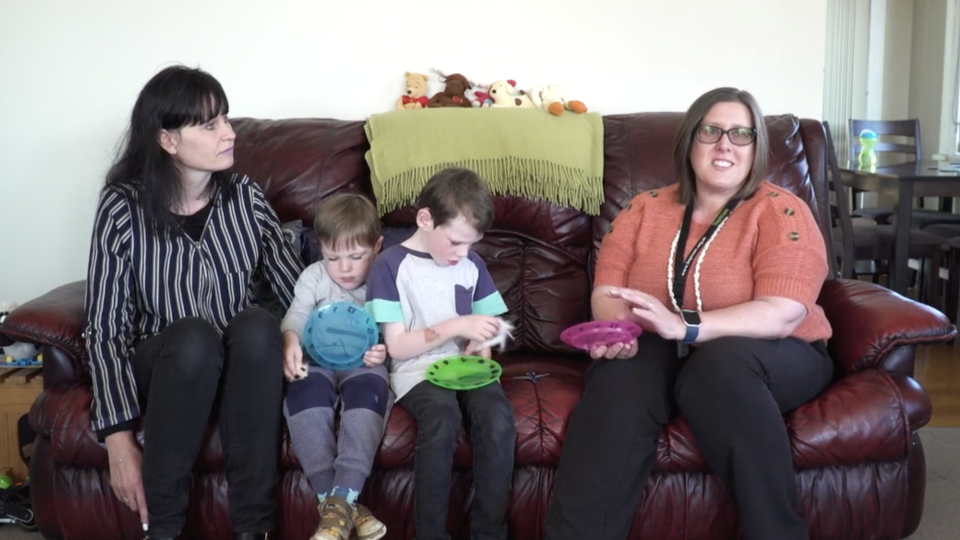 Family with early childhood support sitting on couch