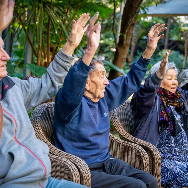 BAPTCARE WESTHAVEN older man and woman in group doing stretching exercises in chair