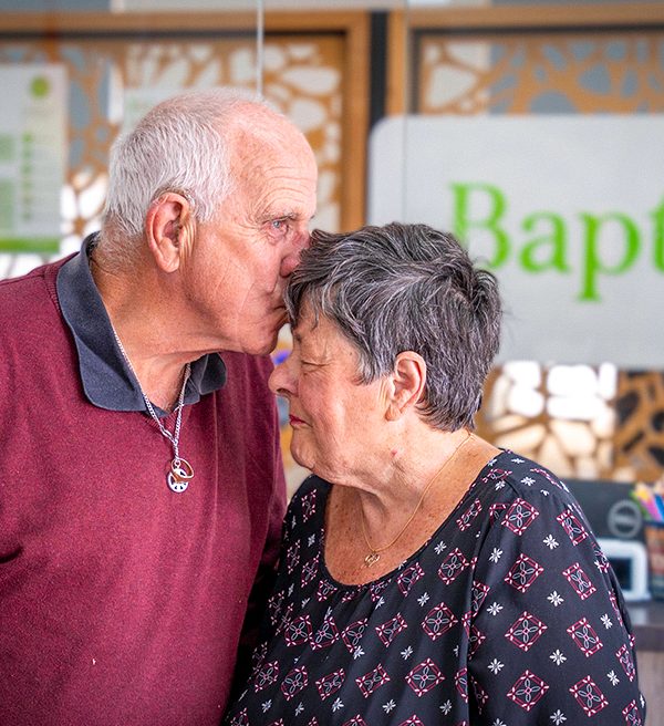 FOSTER CARERS Pam and Joe kiss on the forehead portrait 3