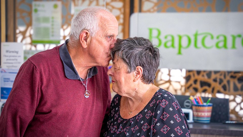 FOSTER CARERS Pam and Joe kiss on the forehead portrait 3